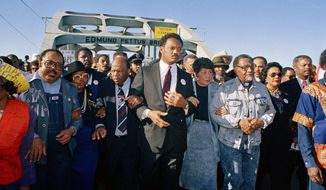 FILE - In this March 4, 1990, file photo, civil rights figures lead marchers across the Edmund Pettus Bridge during the recreation of the 1965 Selma to Montgomery march in Selma, Ala. From left are Hosea Williams of Atlanta, Georgia Congressman John Lewis, the Rev. Jesse Jackson, Evelyn Lowery, SCLC President Joseph Lowery and Coretta Scott King. This Sunday, March 7, 2021, marks the 56th anniversary of those marches and &amp;quot;Bloody Sunday,&amp;quot; when more than 500 demonstrators gathered on March 7, 1965, to demand the right to vote and cross Selma&#39;s Edmund Pettus Bridge. They were met by dozens of state troopers and many were severely beaten. (AP Photo/Jamie Sturtevant, File)