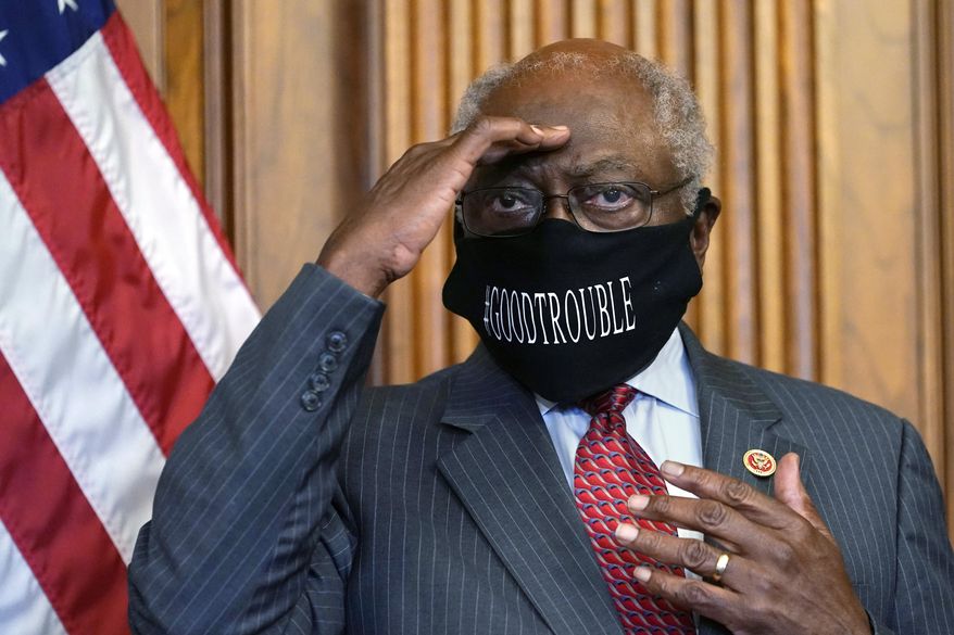 In this Sept. 17, 2020, file photo, House Majority Whip James Clyburn, of S.C., shields his eyes from a television light during a news conference about COVID-19, on Capitol Hill in Washington. (AP Photo/Jacquelyn Martin, File)