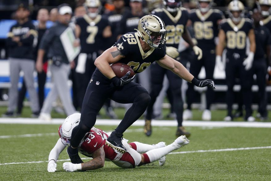 FILE - In this  Sunday, Oct. 27, 2019 file photo, New Orleans Saints tight end Josh Hill (89) carries against Arizona Cardinals cornerback Byron Murphy (33) in the first half of an NFL football game in New Orleans. The New Orleans Saints cut eight-year veteran tight end and special teams regular Josh Hill on Wednesday, March 3, 2021 and also voided the contract of Jared Cook, who was due to become a free agent this offseason. The decision to release the 6-foot-5, 250-pound Hill saves the Saints about $2.6 million in salary cap space for the coming season.(AP Photo/Butch Dill, File)