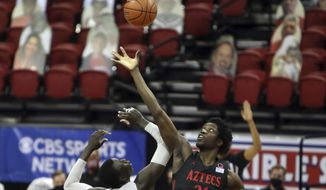 San Diego State&#39;s Nathan Mensah (31) reaches for the tipoff against UNLV&#39;s Cheikh Mbacke Diong (34) during the first half of an NCAA college basketball game Wednesday, March 3, 2021, in Las Vegas. (AP Photo/Joe Buglewicz)