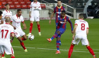 Barcelona&#39;s Ousmane Dembele, 2nd right, attempts a shot at goal during the the Copa del Rey semifinal, second leg, soccer match between FC Barcelona and Sevilla FC at the Camp Nou stadium in Barcelona, Spain, Wednesday March 3, 2021. (AP Photo/Joan Monfort)