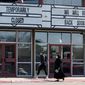 Shoppers pass a theater closed due to the COVID-19 outbreak, Wednesday, March 3, 2021, in San Antonio, Texas. (AP Photo/Eric Gay)  **FILE**