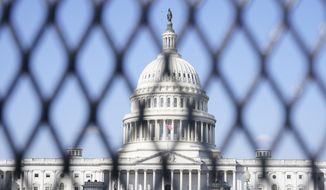 The Capitol is seen through security fencing, Thursday, March 4, 2021, on Capitol Hill in Washington. (AP Photo/Jacquelyn Martin)