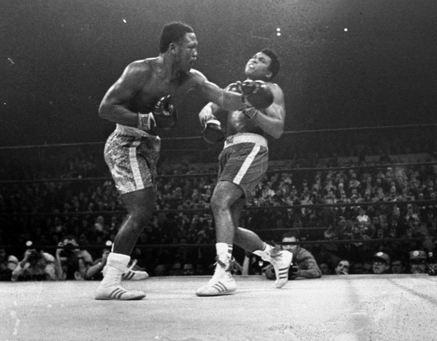 FILE - Joe Frazier hits Muhammad Ali with a left during the 15th round of their heavyweight title fight at New York&#39;s Madison Square Garden, in this March 8, 1971, file photo. Frazier was a relentless puncher filled with rage toward a fighter who couldnt help but belittle him.(AP Photo/File)