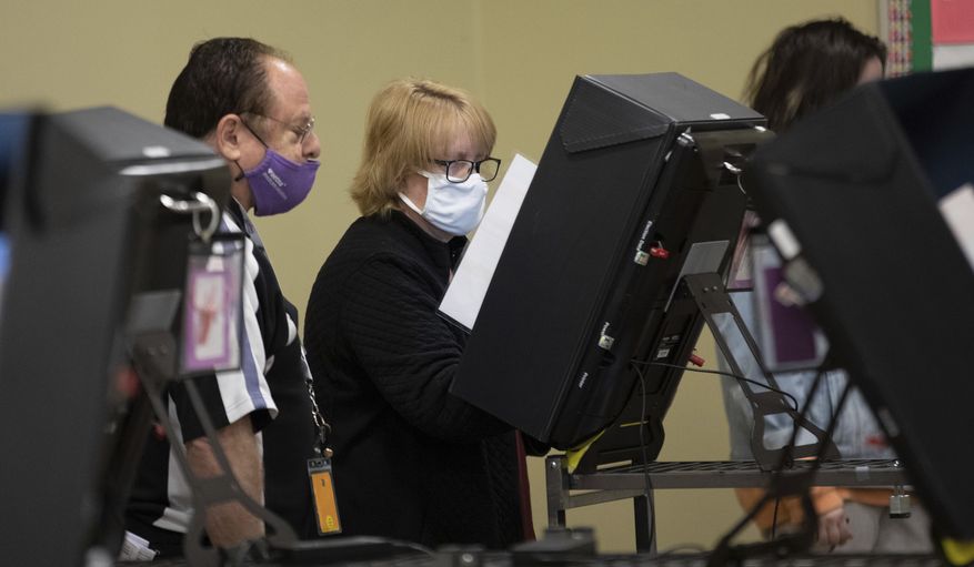 Questions about the integrity of voting systems prompted the U.S. Election Assistance Commission to create new standards. (Associated Press photograph)