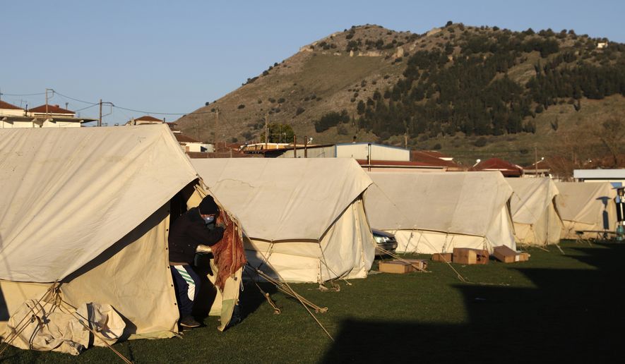 A man exits from a tent at a soccer field after an earthquake in Damasi village, central Greece, Thursday, March 4, 2021. Fearful of returning to their homes, thousands of people in central Greece spent the night outdoors after a powerful earthquake, felt across the region, damaged homes and public buildings. (AP Photo/Vaggelis Kousioras)
