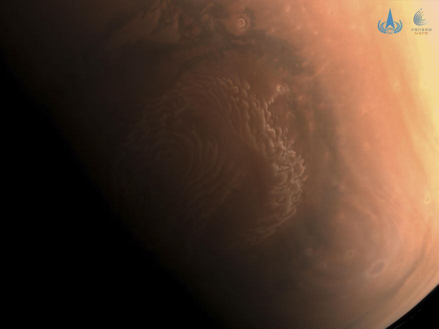 This image made available by the China National Space Administration on Thursday, March 4, 2021, shows a high-resolution photo of the surface of Mars taken by China's Tianwen-1 probe as it orbits the planet in preparation for landing. China says a cohort of astronauts have been selected and are in training to carry out four crewed missions this year as the country works to complete its first permanent orbiting space station. (CNSA via AP)