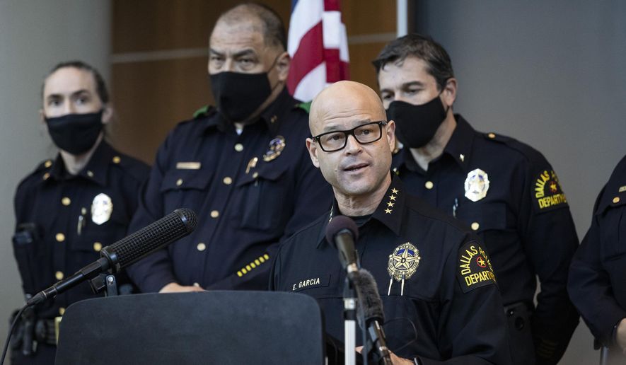 Chief Eddie García, center, speaks with media during a press conference regarding the arrest and capital murder charges against Officer Bryan Riser at the Dallas Police Department headquarters on Thursday, March 4, 2021, in Dallas. Riser was arrested Thursday on two counts of capital murder in two unconnected 2017 killings that weren&#39;t related to his police work, authorities said. (Lynda M. González/The Dallas Morning News via AP)