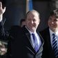 FILE - In this Jan. 8, 2019, file photo, Colorado Gov. Jared Polis, left, waves to the crowd, accompanied by his partner, Marlon Reis, after Polis took the oath of office during his inauguration ceremony in Denver. A newspaper in Colorado said Thursday, March 4, 2021, that Polis proposed to his longtime partner and First Gentleman Marlon Reis in December after 17 years together. (AP Photo/David Zalubowski, Pool, File)