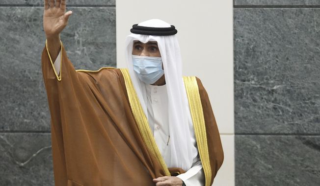 FILE - In this Sept. 30, 2020 file photo, the new Emir of Kuwait Sheikh Nawaf Al Ahmad Al Sabah, waves after he was sworn in at the Kuwaiti National Assembly. Kuwait said Thursday, March 4, 2021, that the 83-year-old ruling emir of Kuwait has flown to the United States for medical checks, just months after ascending the throne. (AP Photo/Jaber Abdulkhaleg, File)
