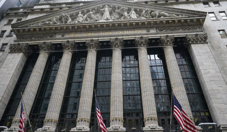 FILE - In this Tuesday, Feb. 16, 2021, American flags hang outside of the New York Stock Exchange in New York. Corporate profits' freefall because of the pandemic is over, at least for now. The last few companies are letting their investors know how much profit they made during the end of 2020, and the numbers have blown past expectations. (AP Photo/Frank Franklin II, File)