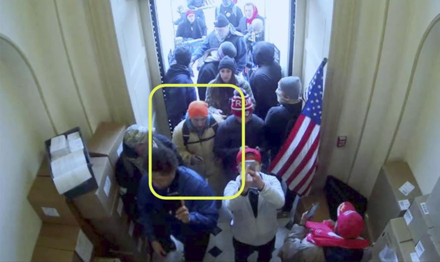 In this image taken from U.S. Capitol Police security camera footage and released in a criminal complaint by the U.S. District Court for the District of Columbia, James Horning, outlined in yellow by the source, joins other rioters who stormed the U.S. Capitol on Jan. 6, 2021, in Washington. Horning, of Ohio, was arrested on Wednesday, Feb. 24 after the FBI received several tips indicating he was inside the federal building alongside the violent mob of Trump supporters, according to a complaint unsealed Monday, March 1. (U.S. District Court for the District of Columbia via AP)