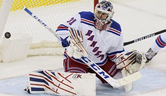 A goal scored by New Jersey Devils center Jack Hughes (86) goes into the net behind New York Rangers goaltender Igor Shesterkin (31) during the first period of an NHL hockey game between the New Jersey Devils and the New York Rangers, Thursday, March 4, 2021, in Newark, N.J. (AP Photo/Kathy Willens)