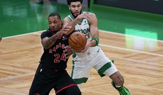 Toronto Raptors guard Norman Powell (24) and Boston Celtics forward Jayson Tatum battle for the ball during the first half of an NBA basketball game, Thursday, March 4, 2021, in Boston. (AP Photo/Charles Krupa)