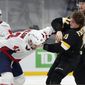 Boston Bruins&#39; Trent Frederic (11) and Washington Capitals&#39; Tom Wilson (43) fight during the third period of an NHL hockey game, Friday, March 5, 2021, in Boston. (AP Photo/Michael Dwyer)