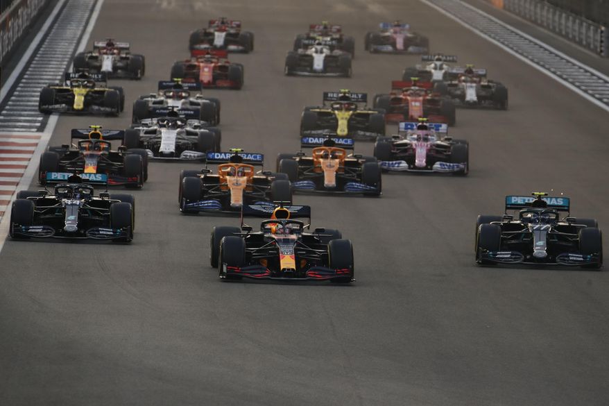 Red Bull driver Max Verstappen of the Netherlands, centre, in action between Mercedes driver Lewis Hamilton of Britain and Mercedes driver Valtteri Bottas of Finland during the Formula One at the Yas Marina racetrack in Abu Dhabi, United Arab Emirates, Sunday, Dec.13, 2020. (Hamad Mohammed, Pool via AP)