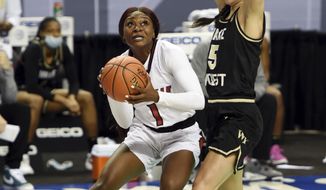 Wake Forest&#x27;s Gina Conti, right, pressures Louisville&#x27;s Dana Evans, left, as she drives to the basket during an NCAA college basketball game at the women&#x27;s Atlantic Coast Conference basketball tournament, Friday, March 5, 2021, in Greensboro, N.C. (Walt Unks/The Winston-Salem Journal via AP, Pool)