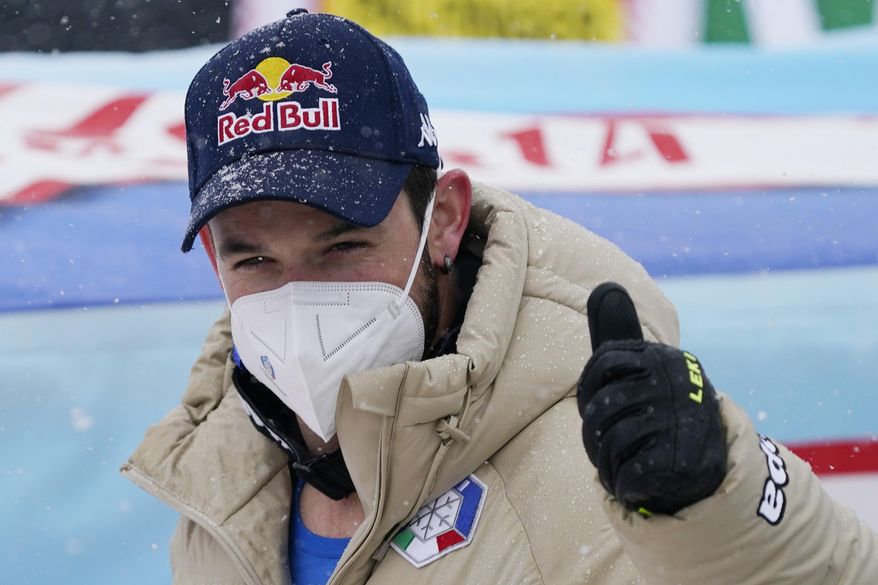Italy's Dominik Paris gives the thumb-up sign after completing an alpine ski, men's World Cup downhill, in Saalbach-Hinterglemm, Austria, Friday, March 5, 2021. (AP Photo/Giovanni Auletta)