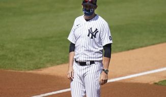 New York Yankees&#39; Manager Aaron Boone stands on the field before a spring baseball game against the Toronto Blue Jays Sunday, Feb. 28, 2021, in Tampa, Fla.  (AP Photo/Frank Franklin II)