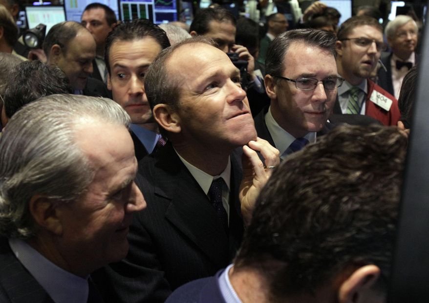 FILE - In this Jan. 26, 2011 file photo, Nielsen Company CEO David Calhoun, center, watches progress as he waits for the company&#x27;s IPO to begin trading, on the floor of the New York Stock Exchange. Boeing CEO David Calhoun declined a salary and performance bonus for most of 2020 but still received stock benefits that pushed the estimated value of his compensation to more than $21 million, according to a regulatory filing Friday, March 5, 2021. (AP Photo/Richard Drew, File)
