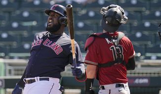 Cleveland Indians designated hitter Franmil Reyes, left, shouts after fouling off a pitch as Arizona Diamondbacks catcher Carson Kelly, right, looks for the ball during the second inning of a spring training baseball game Wednesday, March 3, 2021, in Goodyear, Ariz. (AP Photo/Ross D. Franklin)