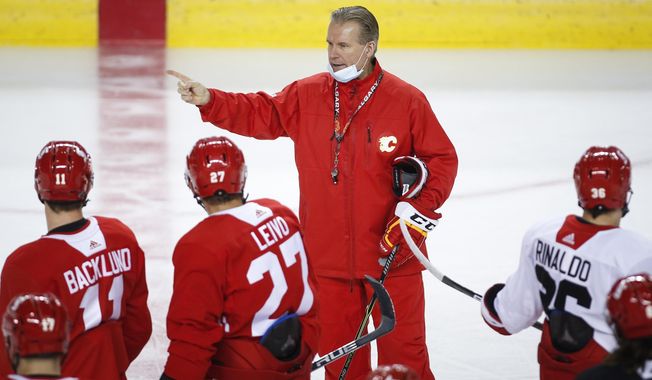 Calgary Flames head coach Geoff Ward gives instruction during a training camp practice in Calgary, Sunday, Jan. 10, 2021. (Jeff McIntosh/The Canadian Press via AP)