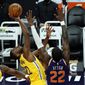 Golden State Warriors forward Andrew Wiggins (22) drives against Phoenix Suns center Deandre Ayton (22) during the first half of an NBA basketball game, Thursday, March 4, 2021, in Phoenix. (AP Photo/Rick Scuteri)