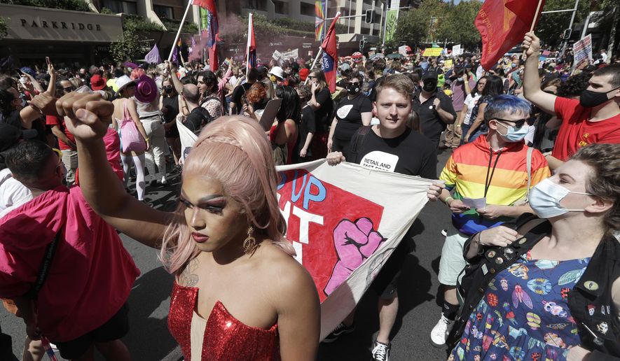 Hundreds of protesters march in Sydney, Saturday, March 6, 2021, ahead of the annual Gay and Lesbian Mardi Gras. The protesters say they want to restore the protest roots of Mardi Gras and challenge systems of injustice. (AP Photo/Rick Rycroft)