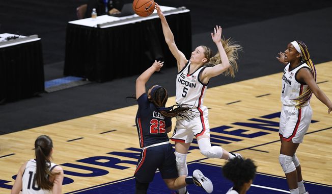 Connecticut&#x27;s Paige Bueckers blocks a shot by St. John&#x27;s Camree Clegg (22) during the first half of an NCAA college basketball game in the quarterfinals of the Big East Conference tournament at Mohegan Sun Arena, Saturday, March 6, 2021, in Uncasville, Conn. (AP Photo/Jessica Hill)
