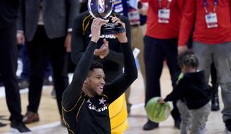 Milwaukee Bucks forward Giannis Antetokounmpo hols up the trophy after basketball&#39;s NBA All-Star Game in Atlanta, Sunday, March 7, 2021. (AP Photo/Brynn Anderson)