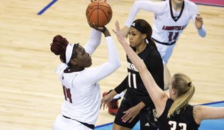 Louisville&#x27;s Olivia Cochran (44) attempts a shot over North Carolina State&#x27;s Elissa Cunane (33) during the championship of Atlantic Coast Conference NCAA women&#x27;s college basketball game in Greensboro, N.C., Sunday, March 7, 2021. (AP Photo/Ben McKeown)