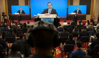 Chinese Foreign Minister Wang Yi speaks during a remote video press conference held on the sidelines of the annual meeting of China&#39;s National People&#39;s Congress (NPC) in Beijing, Sunday, March 7, 2021. (AP Photo/Mark Schiefelbein)