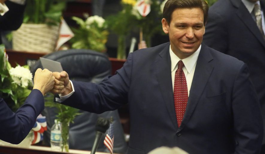 FILE - In this Tuesday, March 1, 2021 file photo, Florida Gov. Ron DeSantis fist bumps with legislators as he enters the House of Representatives prior to his State of the State address at the Capitol in Tallahassee, Fla. Democrats hope to make deeper strides in changing their fortunes in a state that has become friendlier place for Republicans. The state&#39;s only Democrat in statewide office, Agriculture Commissioner Nikki Fried is contemplating a challenge to Republican Gov. DeSantis.  (AP Photo/Phil Sears, File)