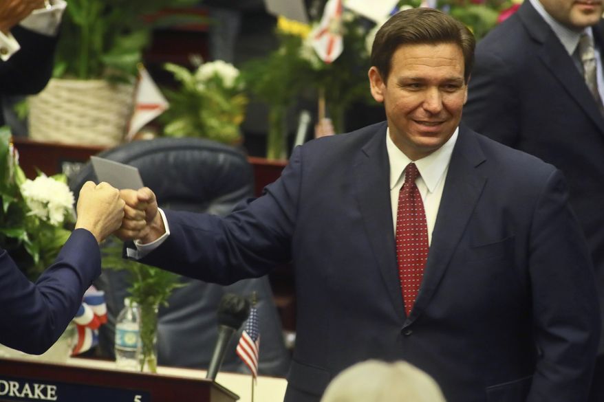 FILE - In this Tuesday, March 1, 2021 file photo, Florida Gov. Ron DeSantis fist bumps with legislators as he enters the House of Representatives prior to his State of the State address at the Capitol in Tallahassee, Fla. Democrats hope to make deeper strides in changing their fortunes in a state that has become friendlier place for Republicans. The state&#39;s only Democrat in statewide office, Agriculture Commissioner Nikki Fried is contemplating a challenge to Republican Gov. DeSantis.  (AP Photo/Phil Sears, File)
