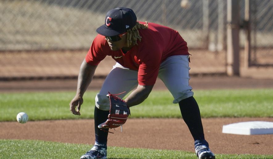 Cleveland Indians third baseman Jose Ramirez fields a ground ball during a spring training baseball practice Monday, Feb. 22, 2021, in Goodyear, Ariz. (AP Photo/Ross D. Franklin)