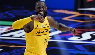 Los Angeles Lakers forward LeBron James smiles during the first half of basketball&#39;s NBA All-Star Game in Atlanta, Sunday, March 7, 2021. (AP Photo/Brynn Anderson)