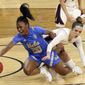 Stanford guard Lacie Hull, right, and UCLA guard Charisma Osborne (20) reach for the ball during the first half of an NCAA college basketball game in the Pac-12 women&#39;s tournament championship Sunday, March 7, 2021, in Las Vegas. (AP Photo/Isaac Brekken)