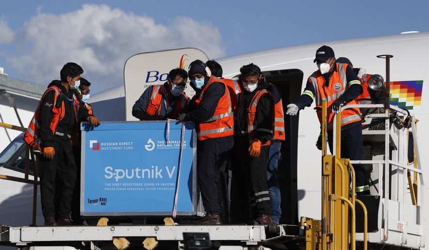 FILE - In this Jan. 28, 2021, file photo, airport employees unload the first shipment of Russia&#39;s Sputnik V COVID-19 vaccine after it arrived at the international airport in El Alto, Bolivia. Russia’s boast in August that it was the first country to authorize a coronavirus vaccine led to skepticism because of its insufficient testing on only a few dozen people. Now, with demand growing for the Sputnik V, experts are raising questions again, this time over whether Moscow can keep up with all the orders from countries that want it. (AP Photo/Juan Karita, File)