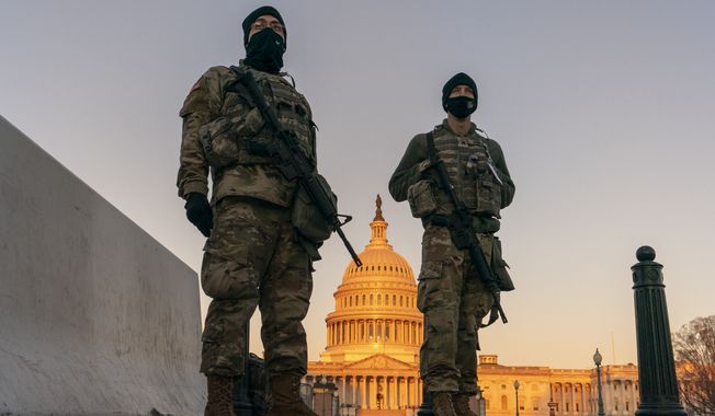 National Guard troops stand their posts around the Capitol at sunrise in Washington, Monday, March 8, 2021. (AP Photo/Carolyn Kaster) **FIILE**