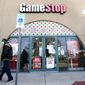 FILE - In this Jan. 28, 2021 file photo, a pedestrian passes a GameStop storefront in Dallas. GameStop shares jumped around 12% in premarket trading Monday, March 8 after the video game retailer appointed a committee it said would aim to “transform GameStop into a technology business.”  (AP Photo/LM Otero, File)
