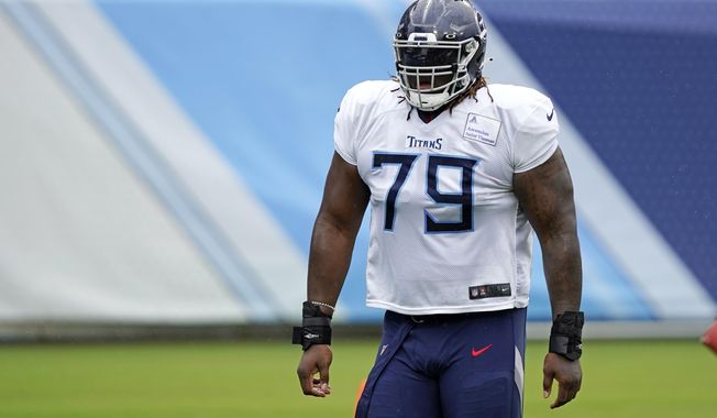 FILE - In this Friday, Aug. 21, 2020, file photo, Tennessee Titans offensive tackle Isaiah Wilson waits for his turn to run a drill during NFL football training camp in Nashville, Tenn. A person familiar with the deal said Monday, March 8, 2021, that the Tennessee Titans have traded offensive lineman Wilson to the Miami Dolphins in a move unloading their first-round draft pick after his rookie season. (AP Photo/Mark Humphrey, Pool, File)