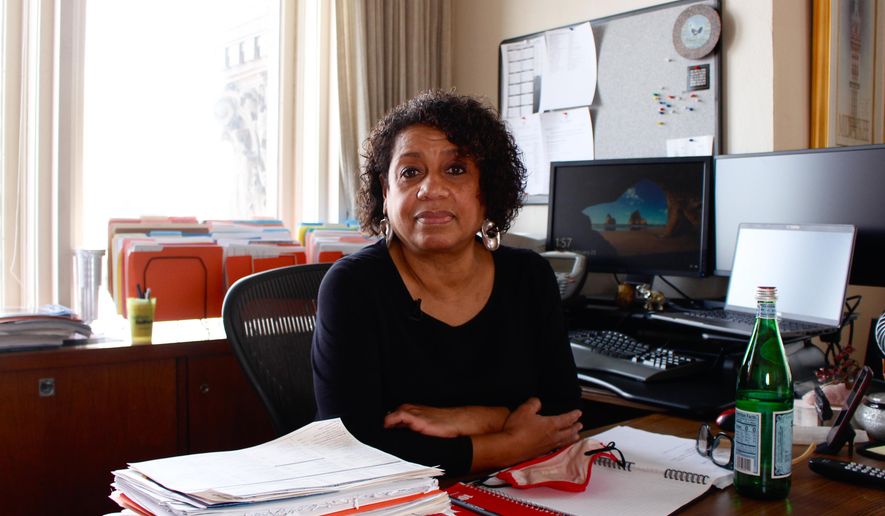Kimberly Montgomery sits for a photo in her office in City Hall on Feb. 23, 2020, in Milwaukee. Montgomery lost 15 people in her life to COVID-19. "I don't know if I ever will ever be able to process all of them," she said. (AP Photo/Carrie Antlfinger)