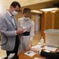 This file photo released on July 19, 2020, on the official Facebook page of the Syrian Presidency, shows Syrian President Bashar Assad, left, and his wife Asma voting at a polling station in the parliamentary elections, in Damascus, Syria. (Syrian Presidency via AP, File)