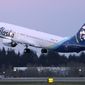 The first Alaska Airlines passenger flight on a Boeing 737-9 Max airplane takes off, Monday, March 1, 2021, on a flight to San Diego from Seattle-Tacoma International Airport in Seattle.   Boeing says it got more new orders than cancellations for planes in February.  Boeing said Tuesday, March 9, that it received 82 new orders and 51 cancellations last month, for a net gain of 31.    (AP Photo/Ted S. Warren, File)