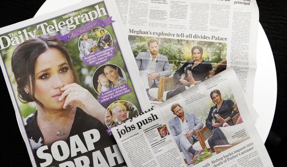 Australian newspapers report in Sydney, Tuesday, March 9, 2021, on an interview of The Duke and Duchess of Sussex by Oprah Winfrey. (AP Photo/Rick Rycroft)