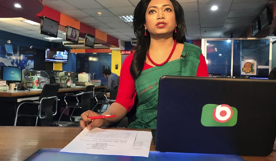 Bangladesh's first transgender news anchor Tashnuva Anan Shishir reads news bulletin , in Dhaka, Bangladesh, Tuesday, March 9, 2021. A Bangladeshi satellite television station has signed up the South Asian county's first transgender news anchor with a hope to remove the deeply-rooted social stigma they face. Shishir, who previously worked as a rights activist and an actor, appeared before audience on Monday after her appointment recently as the day coincided with the International Women's Day. She made the debut by reading a three-minute daily news bulletin on Dhaka-based Boishakhi TV. (AP Photo/Al-emrun Garjon)