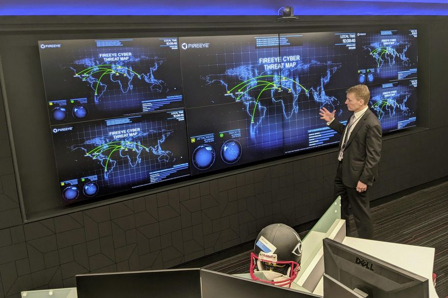 The CEO of FireEye Kevin Mandia gives a tour of the cybersecurity company's unused office space in Reston, Va., Tuesday, March 9, 2021. Mandia said 550 of his employees are working remotely and responding to a recent barrage of cyber breaches, including four different zero-day attacks against Microsoft Exchange. (AP Photo/Nathan Ellgren)