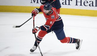 Washington Capitals center Evgeny Kuznetsov (92) shoots during the first period of the tema&#39;s NHL hockey game against the New Jersey Devils, Tuesday, March 9, 2021, in Washington. (AP Photo/Nick Wass) **FILE**