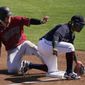 Arizona Diamondbacks&#x27; Josh VanMeter (19) steals third base as Cleveland Indians third baseman Jose Ramirez, right, is unable to control the throw during the third inning of a spring training baseball game Wednesday, March 3, 2021, in Goodyear, Ariz. (AP Photo/Ross D. Franklin)