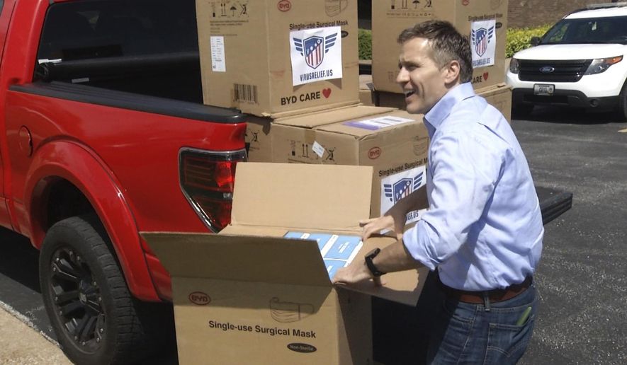 In this April 27, 2020 image from video provided by KRCG-TV, former Missouri Gov. Eric Greitens delivers masks to first responders in Columbia, Mo. Greitens passed out masks across the state in the early days of the coronavirus pandemic last spring. (KRCG-TV via The AP)
